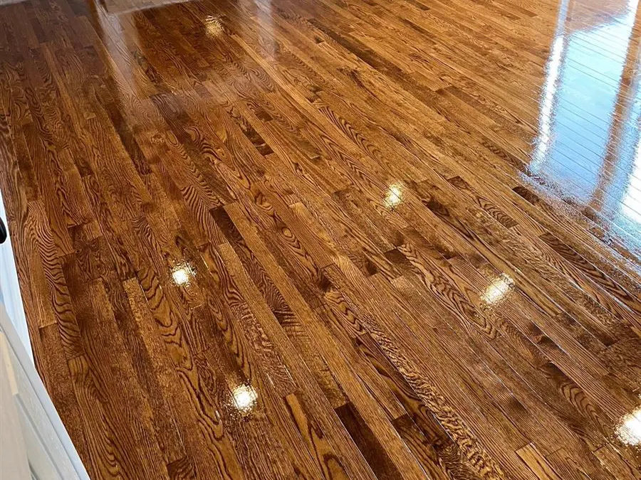 Refinished oak strip floor in a living room with a fireplace