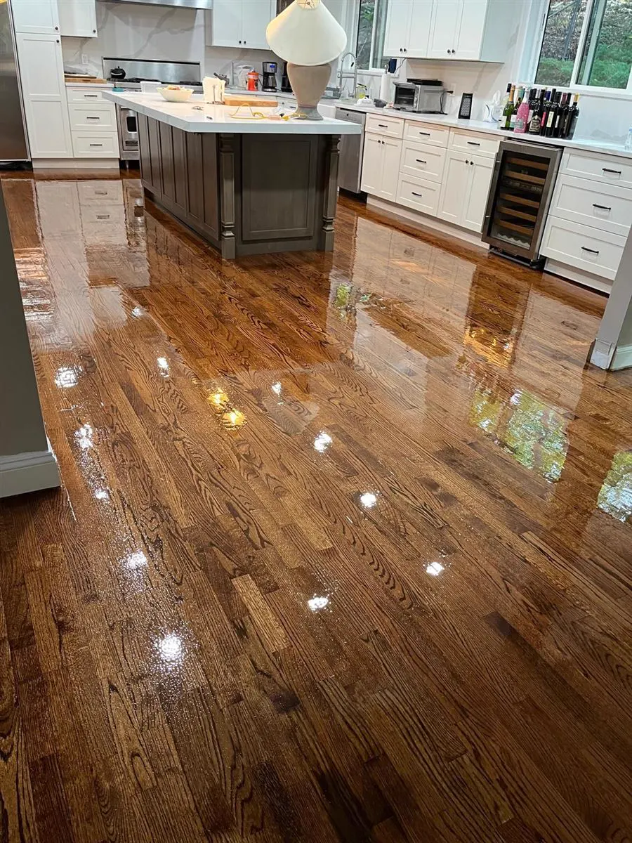 Oak floor with a gloss finish in a kitchen with white cabinets